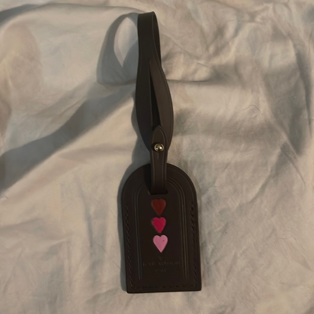 Louis Vuitton luggage tag heat stamped w/three hearts.